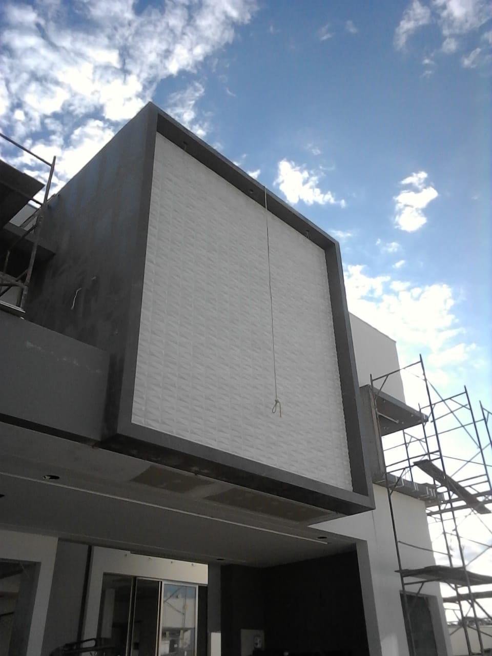 Exterior wall tile cladding mid-installation by BBJ Flooring Corp