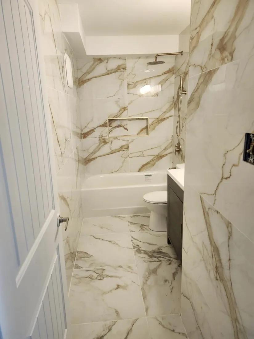 Finished marble-look tub and shower combo installed by BBJ Flooring Corp
