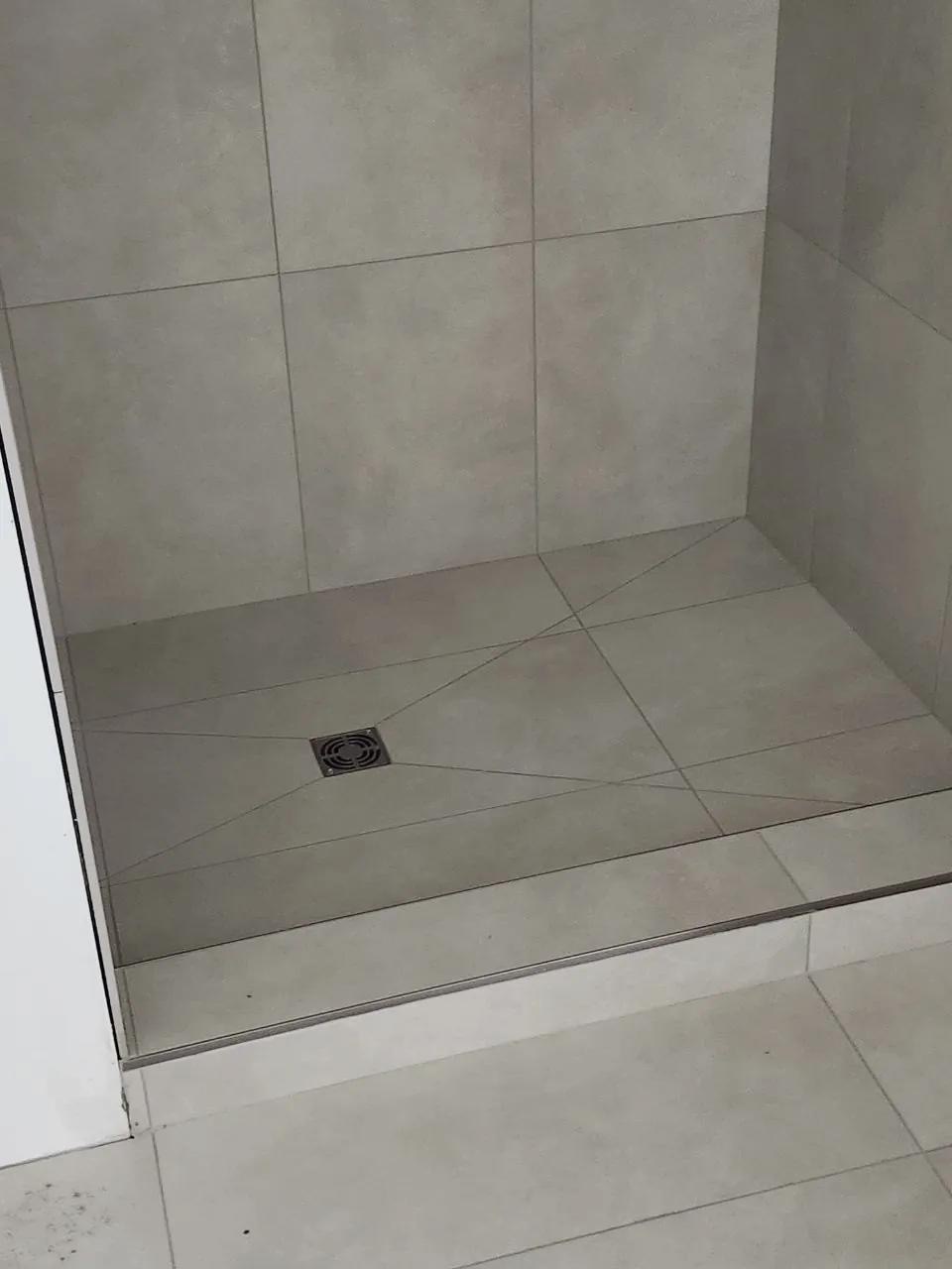 Finished tiled shower floor with linear drain installed by BBJ Flooring Corp