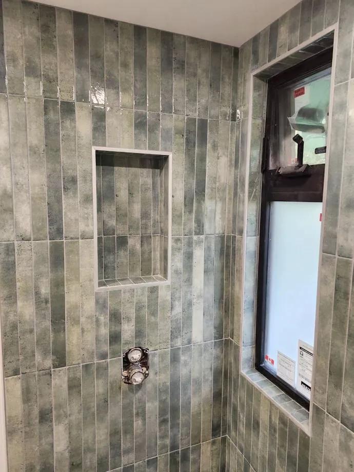 Finished vertical tile shower niche installed by BBJ Flooring Corp